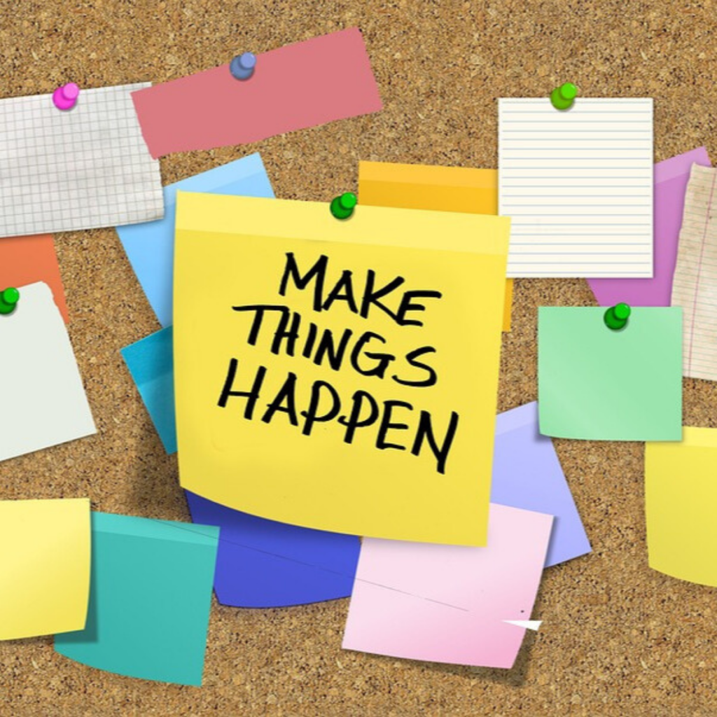 A motivational note with the phrase “make things happen” pinned to a cork board, surrounded by various colorful blank sticky notes.
