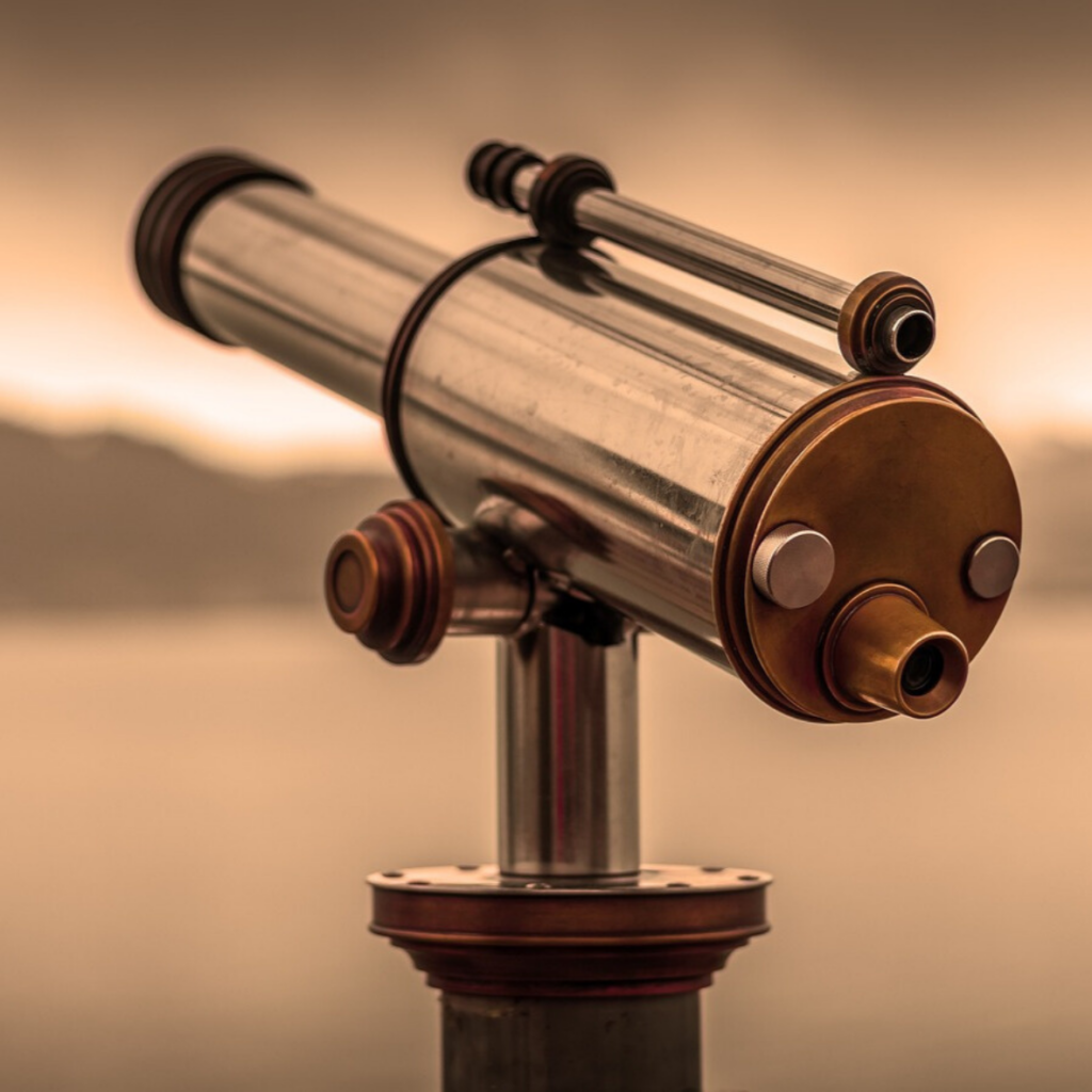 Vintage style telescope overlooking view with sepia background.