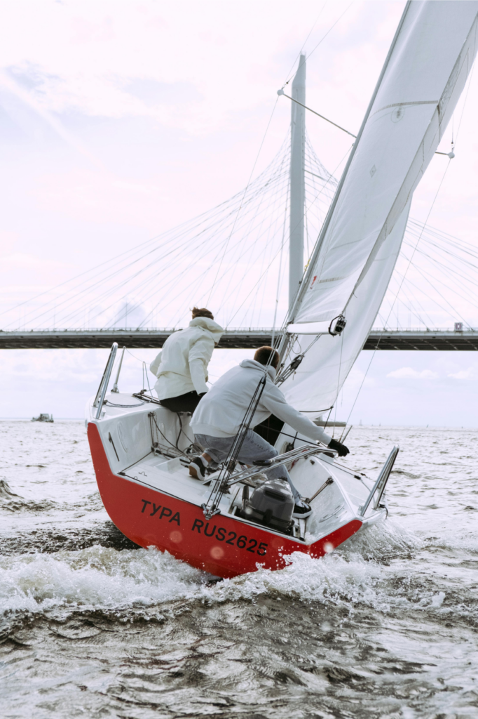 Two people on a sailboat.