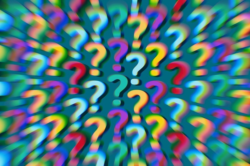 Plusieurs points d'interrogation colorés avec un effet de zoom flou sur un fond sombre, évoquant l'intrigue de comprendre les RH.